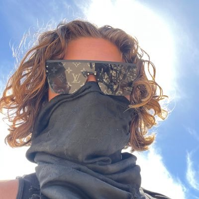 TJR in Louis Vuitton sunglasses against blue sky